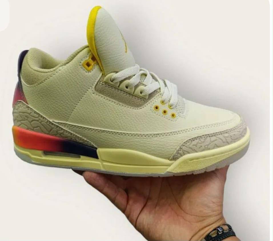 Pale yellow sneaker held in hand