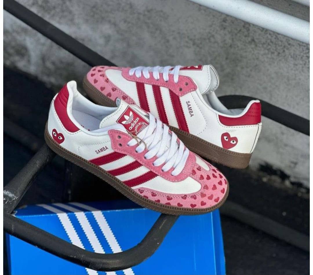 Pink and white sneakers on a blue box