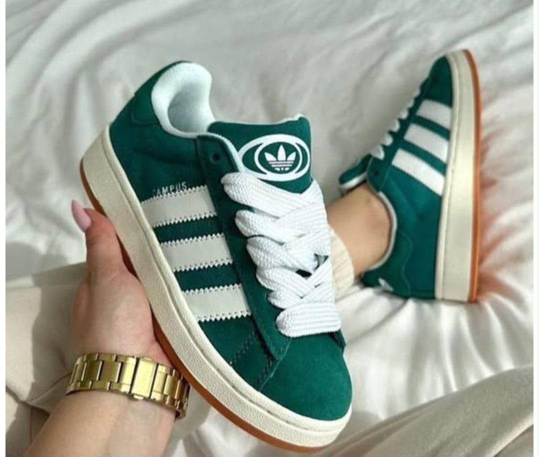 Green and white sneakers worn with cream trousers